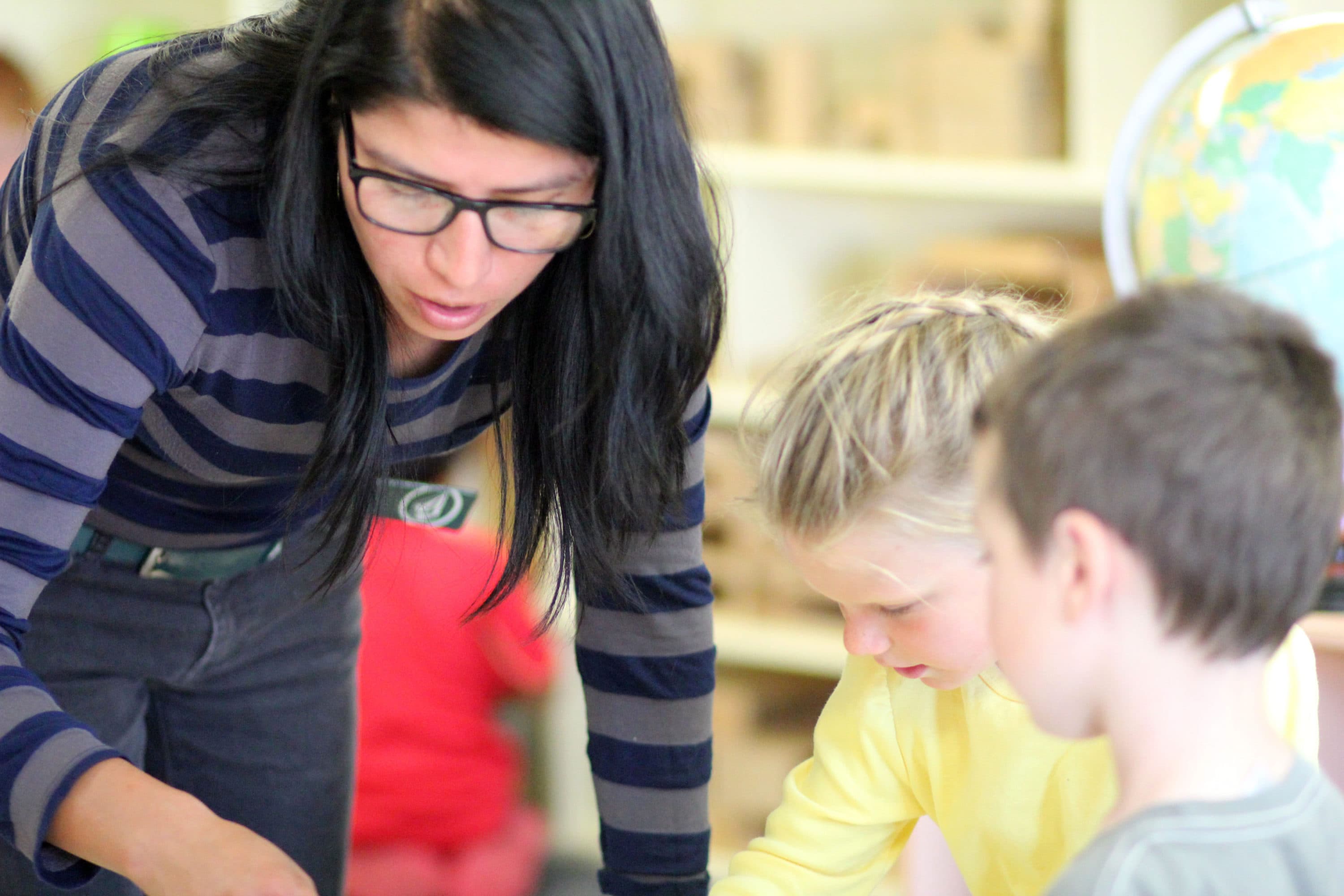 A staff member works with children at Centro VIDA Children's Center. (Courtesy of the Center for the Study of Child Care Employment)