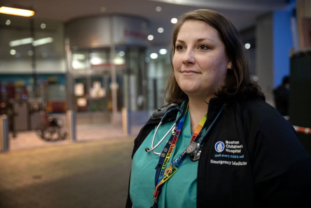 Emergency Physician Amanda Stewart talks with a colleague outside the emergency entrance to Boston Children's Hospital. (Robin Lubbock/WBUR)