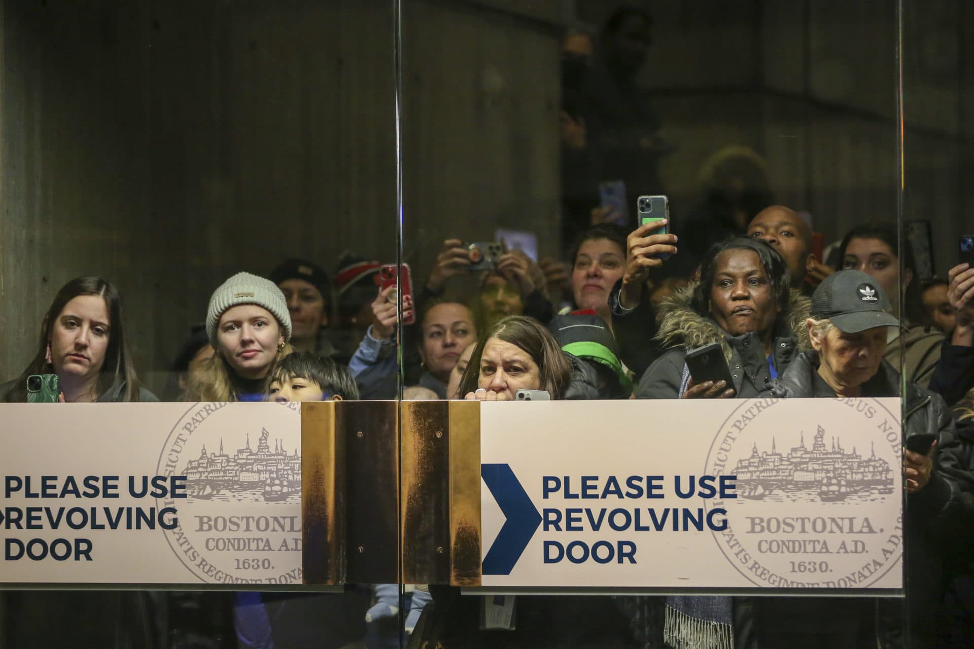 People wait for Prince William and Kate to walk through the lobby of Boston City Hall on Wednesday, Nov. 30, 2022, in Boston, Mass. (Reba Saldanha/AP)