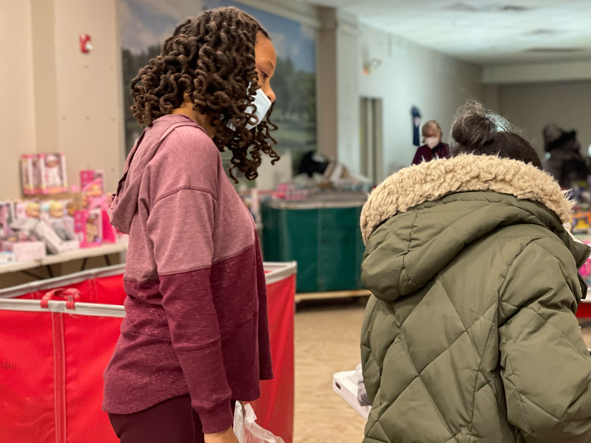 At 38 Bromfield Street, volunteers led parents through an improvised storefront looking for holiday gifts for their children. (Max Larkin/WBUR)