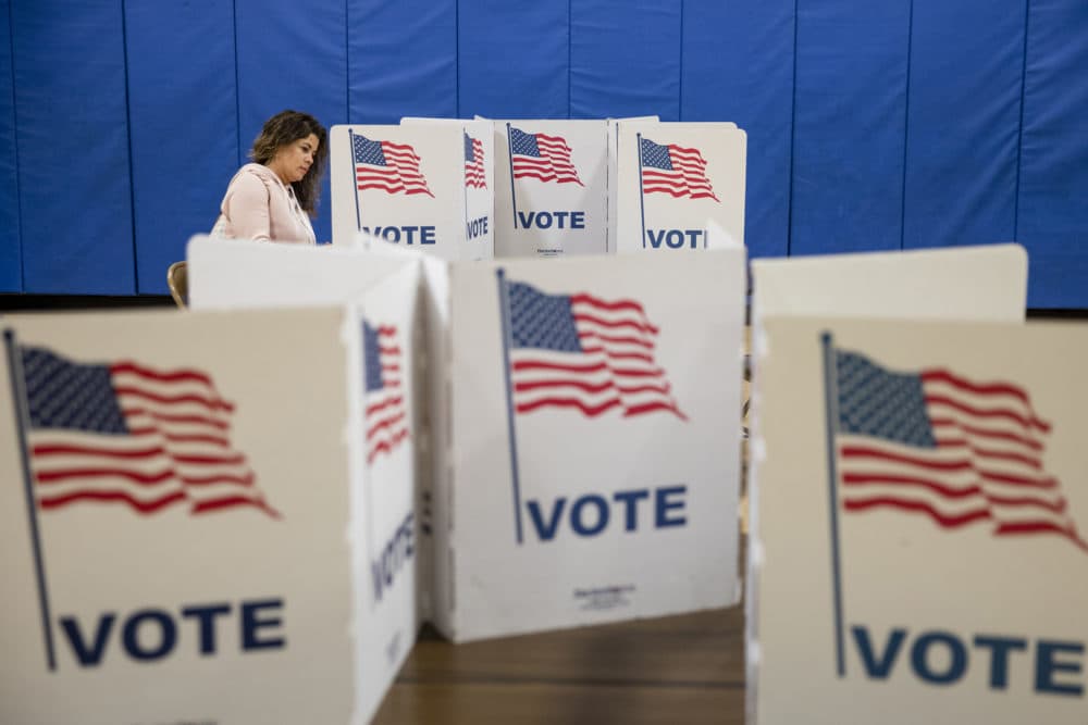 A woman marks down her vote on a ballot for the Democratic presidential primary election at a polling place in Armstrong Elementary School on Super Tuesday, March 3, 2020 in Herndon, Virginia. (Samuel Corum/Getty Images)