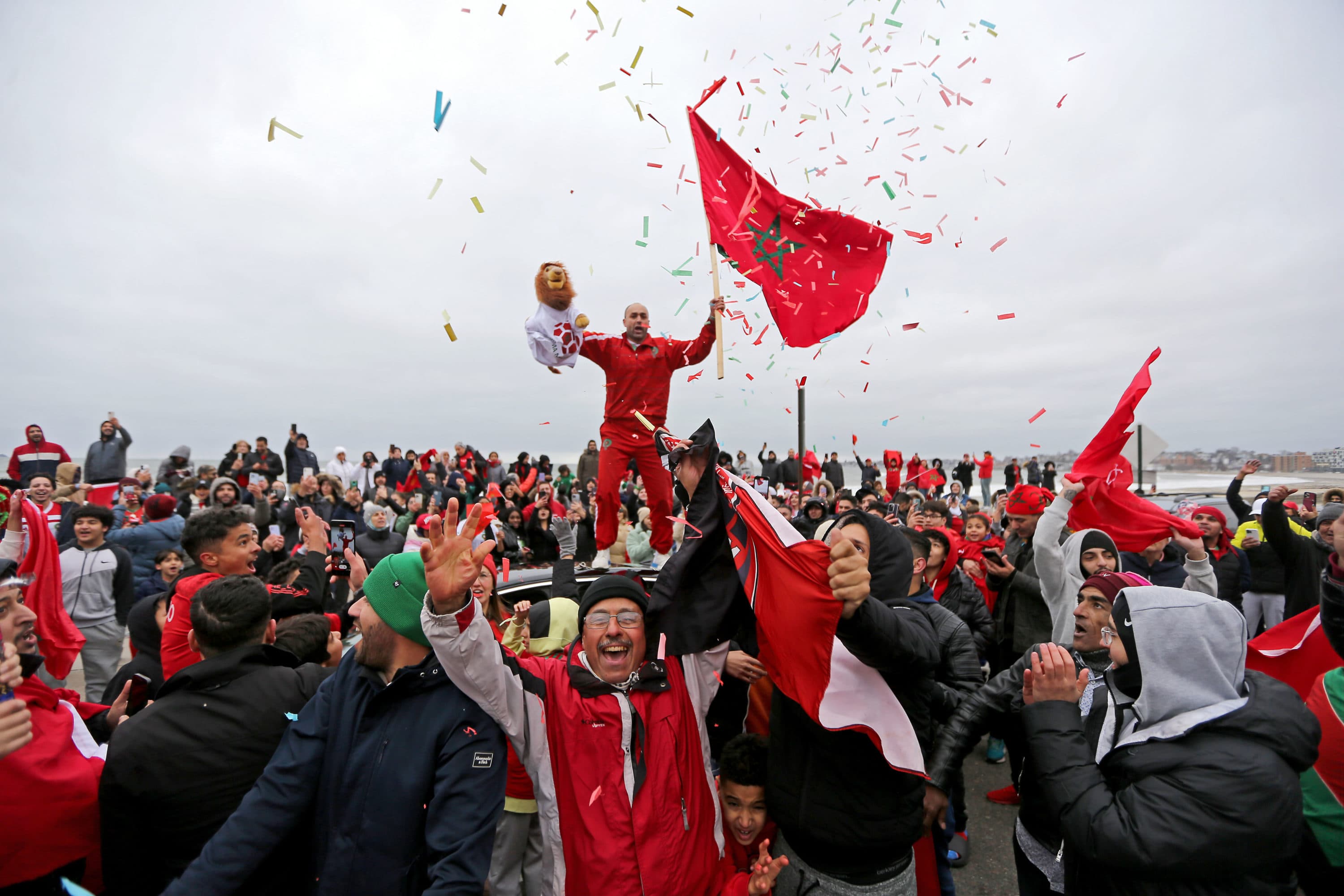 Local Moroccans celebrate Morocco's win in the quarter finals of the World Cup along Revere Beach on Dec. 10, 2022, in Revere. (Stuart Cahill/Boston Herald via Getty Images)