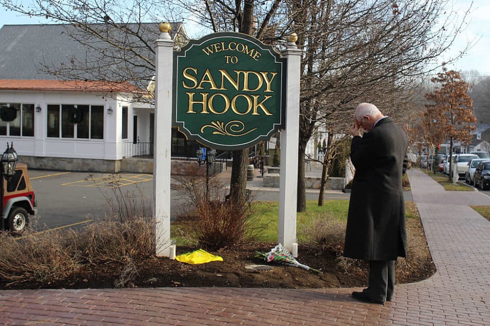 On Dec. 15, 2012, Steve Wruble stands in silence and thought at the Sandy Hook town sign a day after the mass shooting at Sandy Hook Elementary School, Newtown, Connecticut. (Tim Clayton/Corbis via Getty Images)
