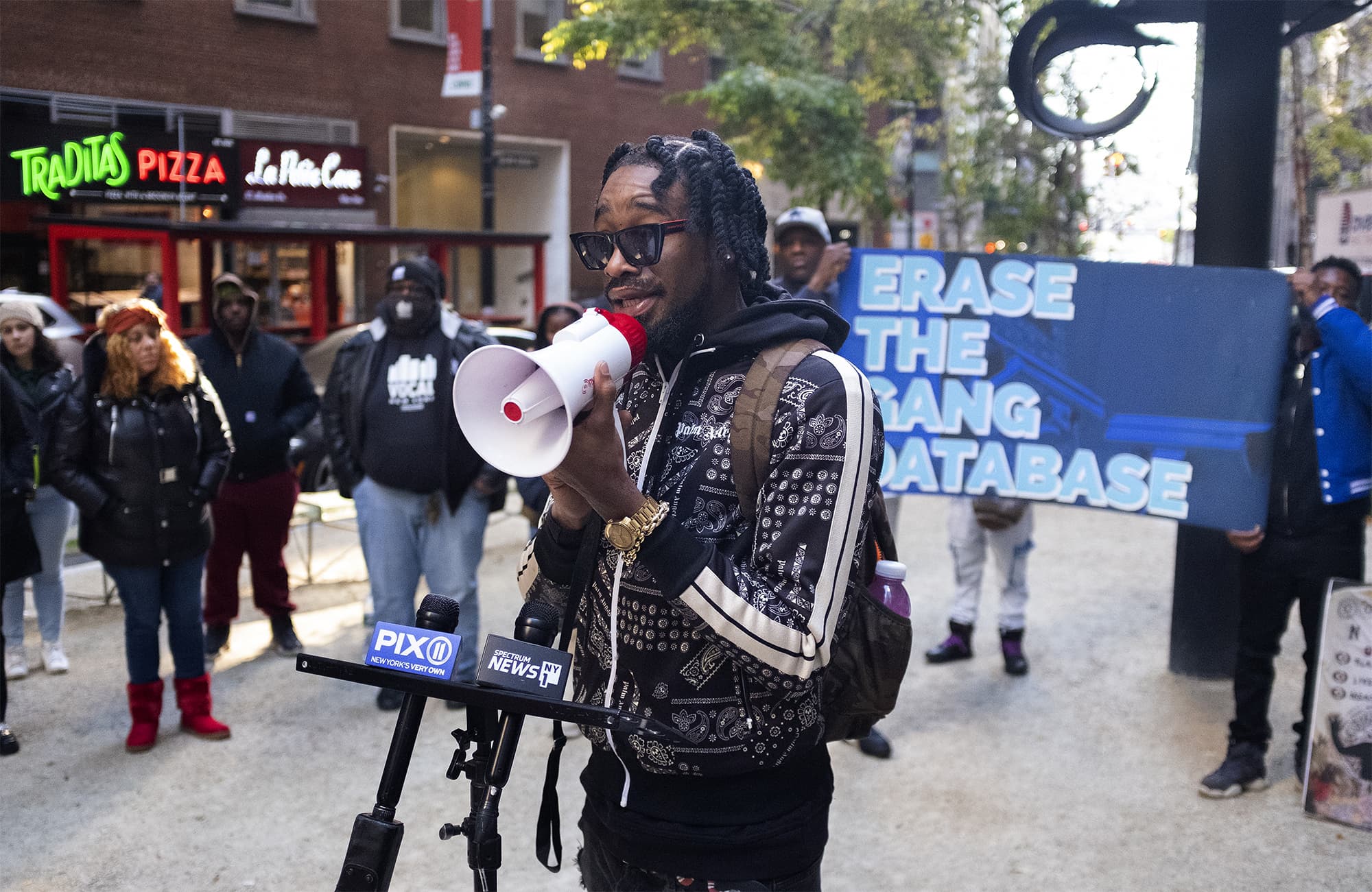 Kraig Lewis at a November 2022 rally outside New York City's Department of Investigation. Lewis and other activists want the DOI to release a report that looks into the Controversial police department's gang database. (Carolina Hidalgo/WNYC)