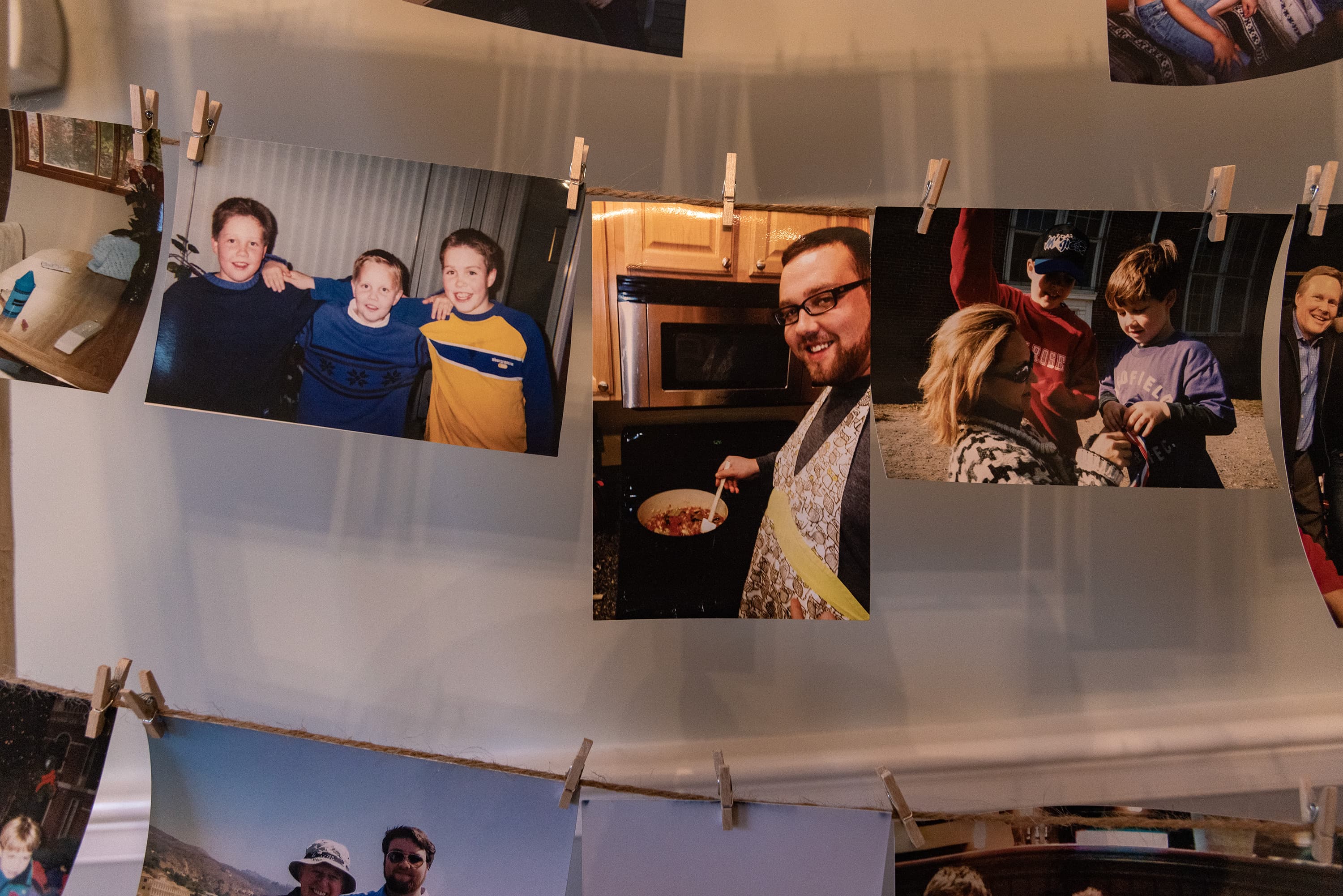 Photographs of Michael Conlon hang as a celebration of his life in his parent's dining room. (Jesse Costa/WBUR)