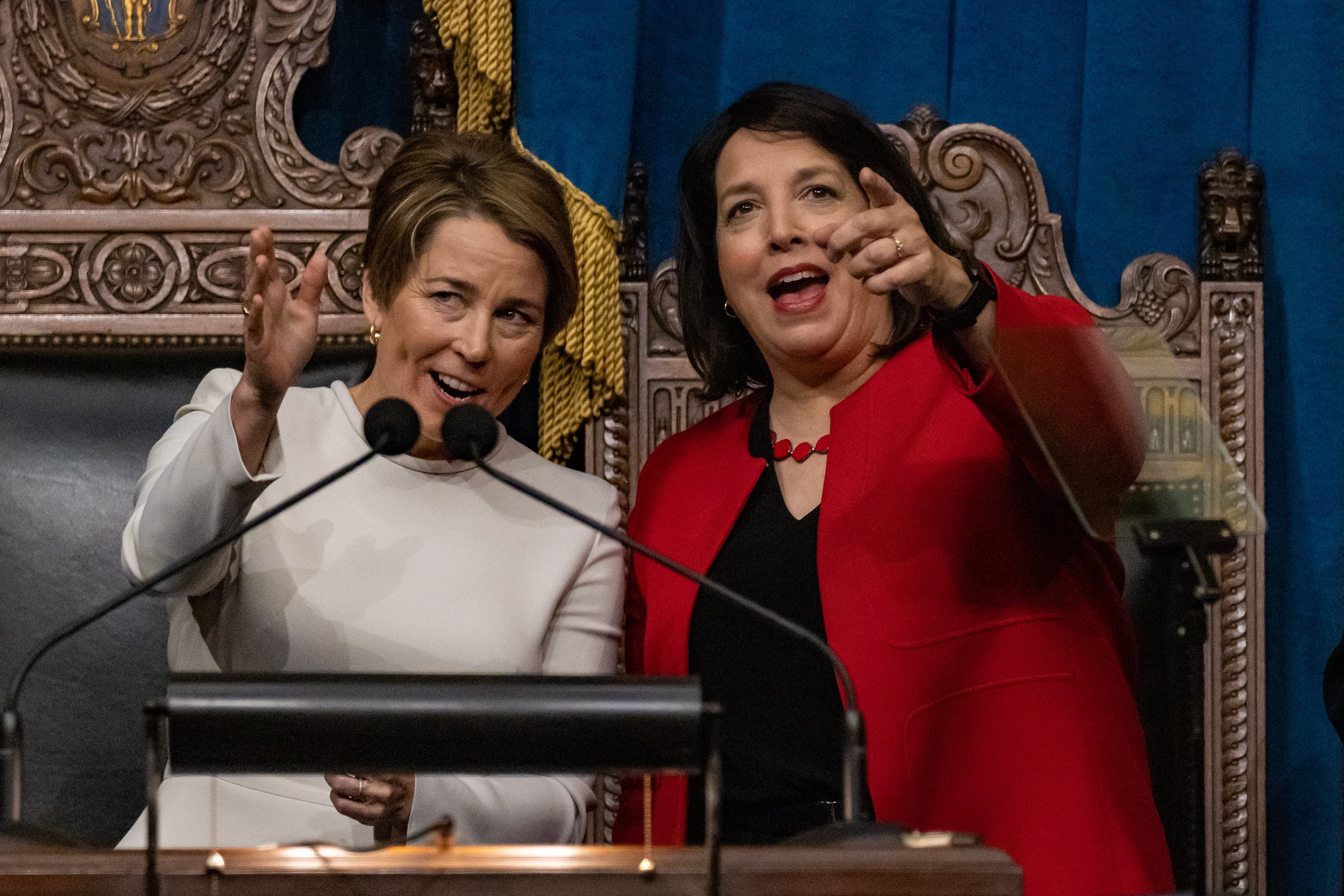 Governor Maura Healey and Lt. Governor Kim Driscoll point up at the crowd in the balcony of the House Chamber after the conclusion of their inaugural at the State House. (Jesse Costa/WBUR)