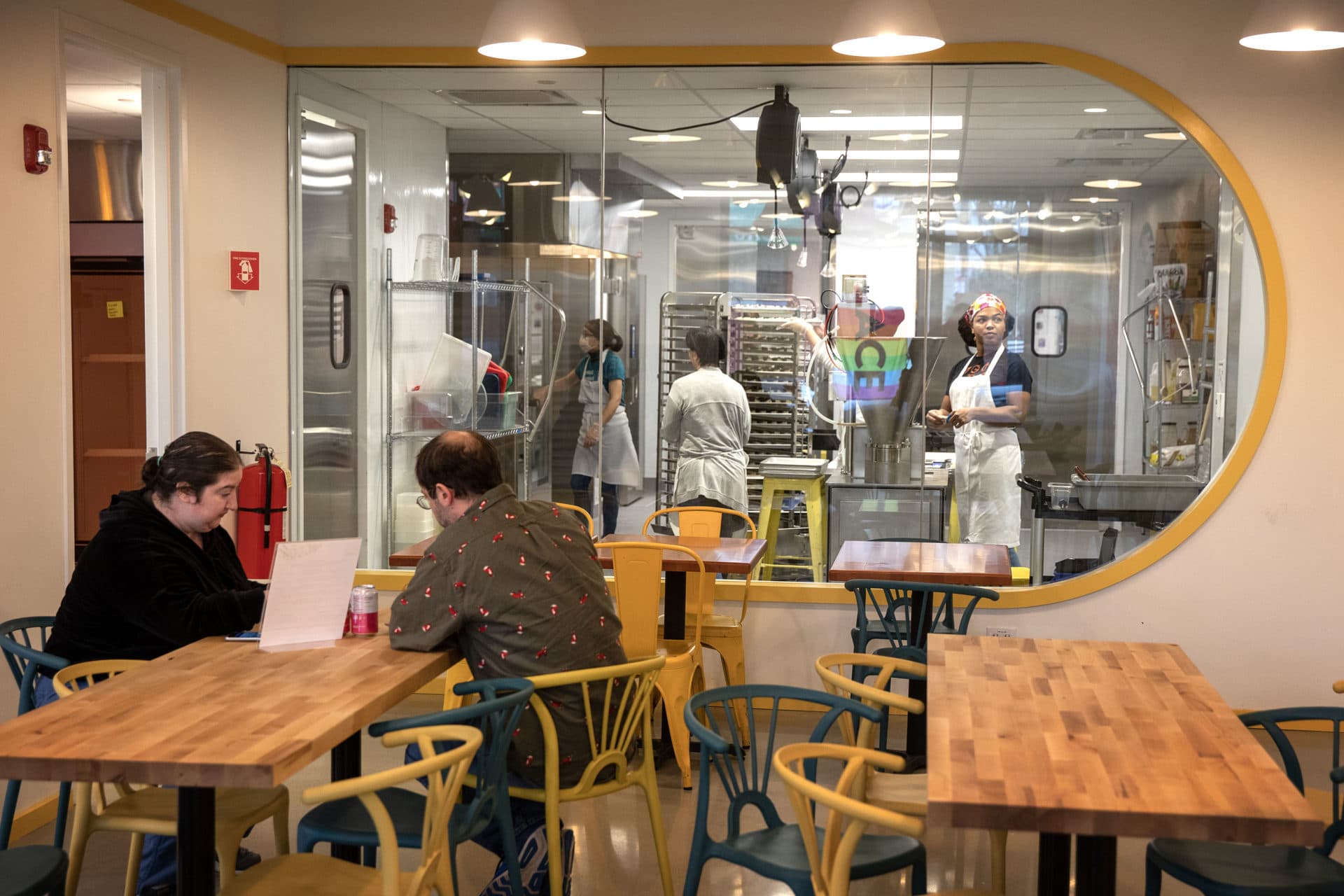 Customers sit in the restaurant area at Mei Mei, where they can watch dumpling production in progress. (Robin Lubbock/WBUR)