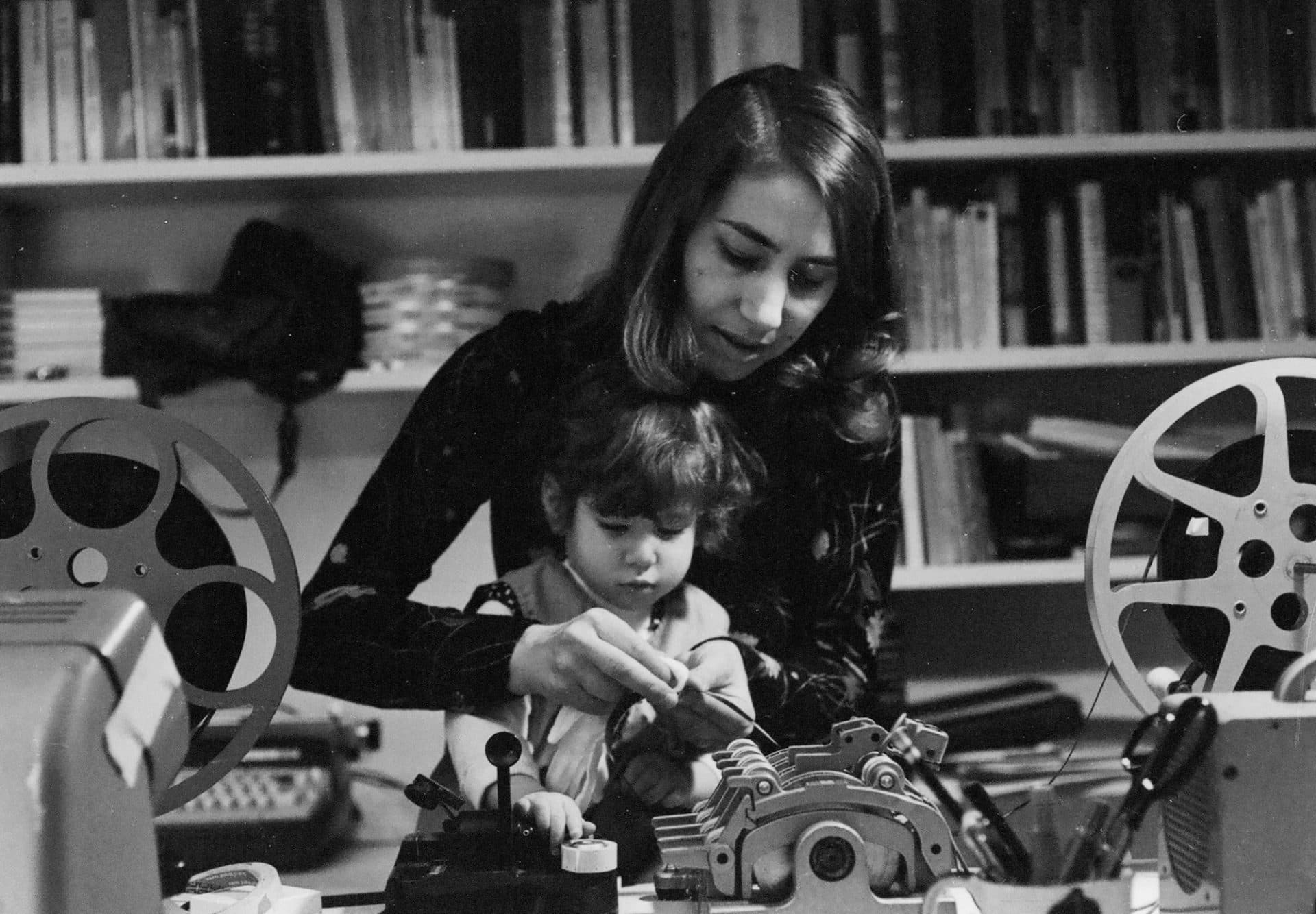 Joyce Chopra editing with her young child on her lap. (Courtesy Harvard Film Archive)