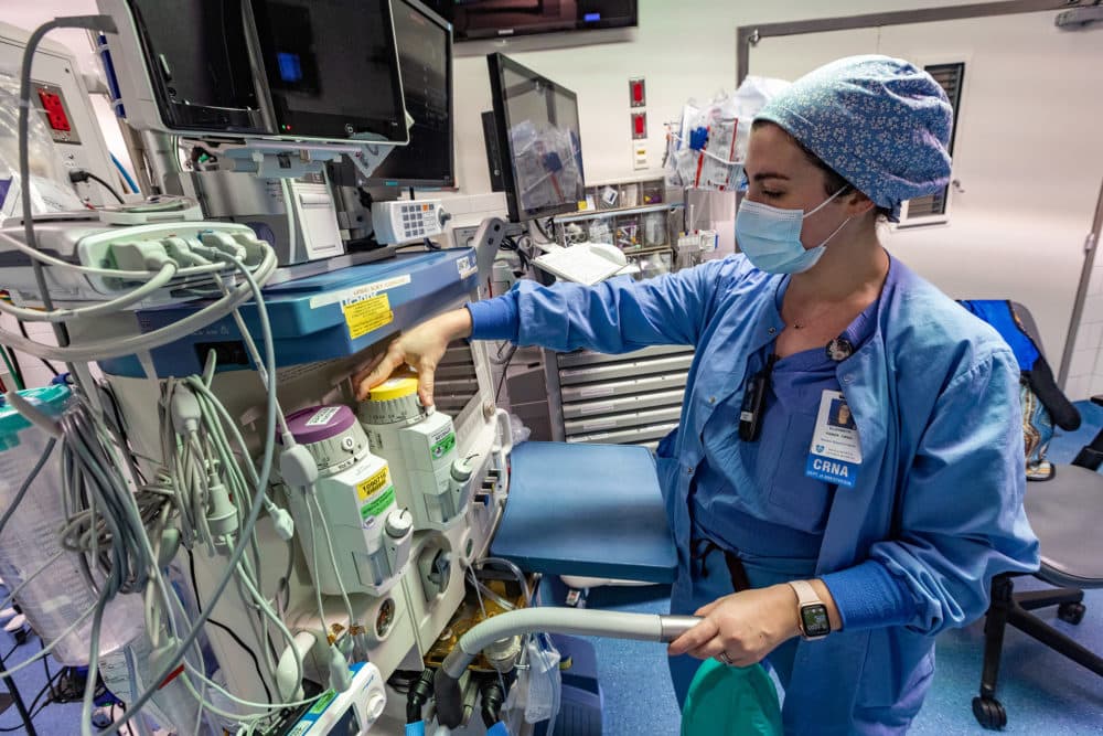 Nurse anesthetist Liz Faber regulates the amount of sevoflurane she'll use for a procedure in one of the operating rooms at Massachusetts General Hospital. (Jesse Costa/WBUR)