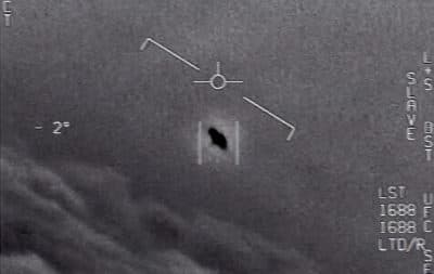 The image from video provided by the Department of Defense labelled Gimbal, from 2015, an unexplained object is seen at center as it is tracked as it soars high along the clouds, traveling against the wind. (Department of Defense via AP)
