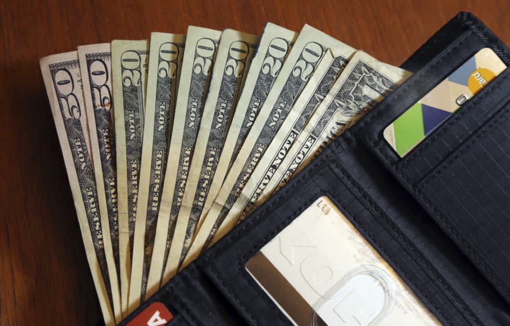 In this June 15, 2018, file photo, cash is fanned out from a wallet in North Andover, Mass. (Elise Amendola/AP)