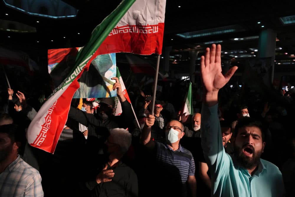 Mourners chant slogans as they wave Iranian national flag during a ceremony marking anniversary of the death of the late Revolutionary Guard Gen. Qassem Soleimani, who was killed in Iraq. (Vahid Salemi/AP)