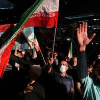 Mourners chant slogans as they wave Iranian national flag during a ceremony marking anniversary of the death of the late Revolutionary Guard Gen. Qassem Soleimani, who was killed in Iraq. (Vahid Salemi/AP)