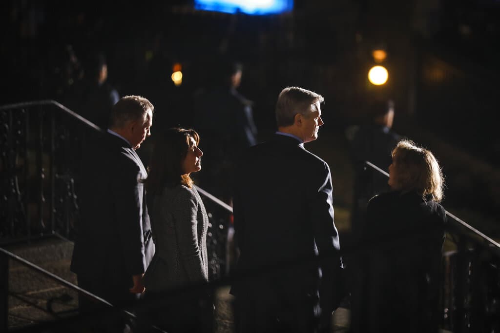 Massachusetts Gov. Charlie Baker with his wife Lauren Baker, right, Lt. Gov. Karyn Polito, and and Polito's husband, Steve Rodolakis, left, takes his last walk through the State House, Wednesday, Jan. 4, 2023, in Boston. (Erin Clark/The Boston Globe via pool)