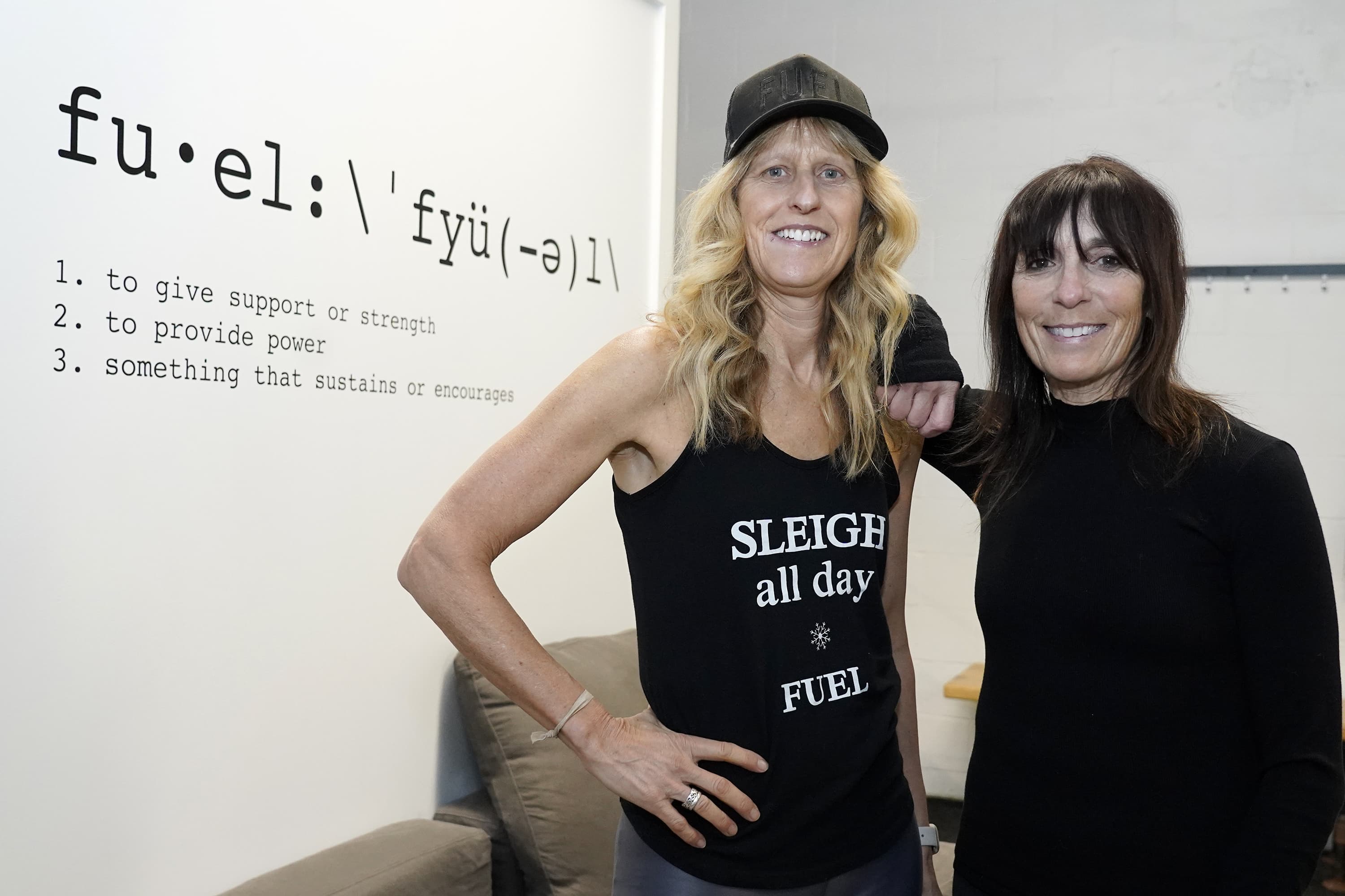 Fuel Training Studio owners Julie Bokat, left, and Jeanne Carter pose for a photo inside their gym, Thursday, Jan. 19, 2023, in Newburyport, Mass. (Mary Schwalm/AP)
