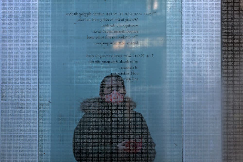 Boston, MA - January 27: A person studies the inscription a glass tower while visiting the New England Holocaust Memorial in Boston, MA on International Holocaust Remembrance Day January 27, 2022. Founded by Holocaust survivor Stephan Ross, the memorial is designed to inspire remembrance, reflection, and hope. (Photo by Craig F. Walker/The Boston Globe via Getty Images)