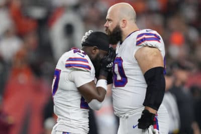 Tre'Davious White #27 and Mitch Morse #60 of the Buffalo Bills react to teammate Damar Hamlin #3 collapsing after making a tackle against the Cincinnati Bengals during the first quarter at Paycor Stadium on January 02, 2023 in Cincinnati, Ohio. (Dylan Buell/Getty Images)