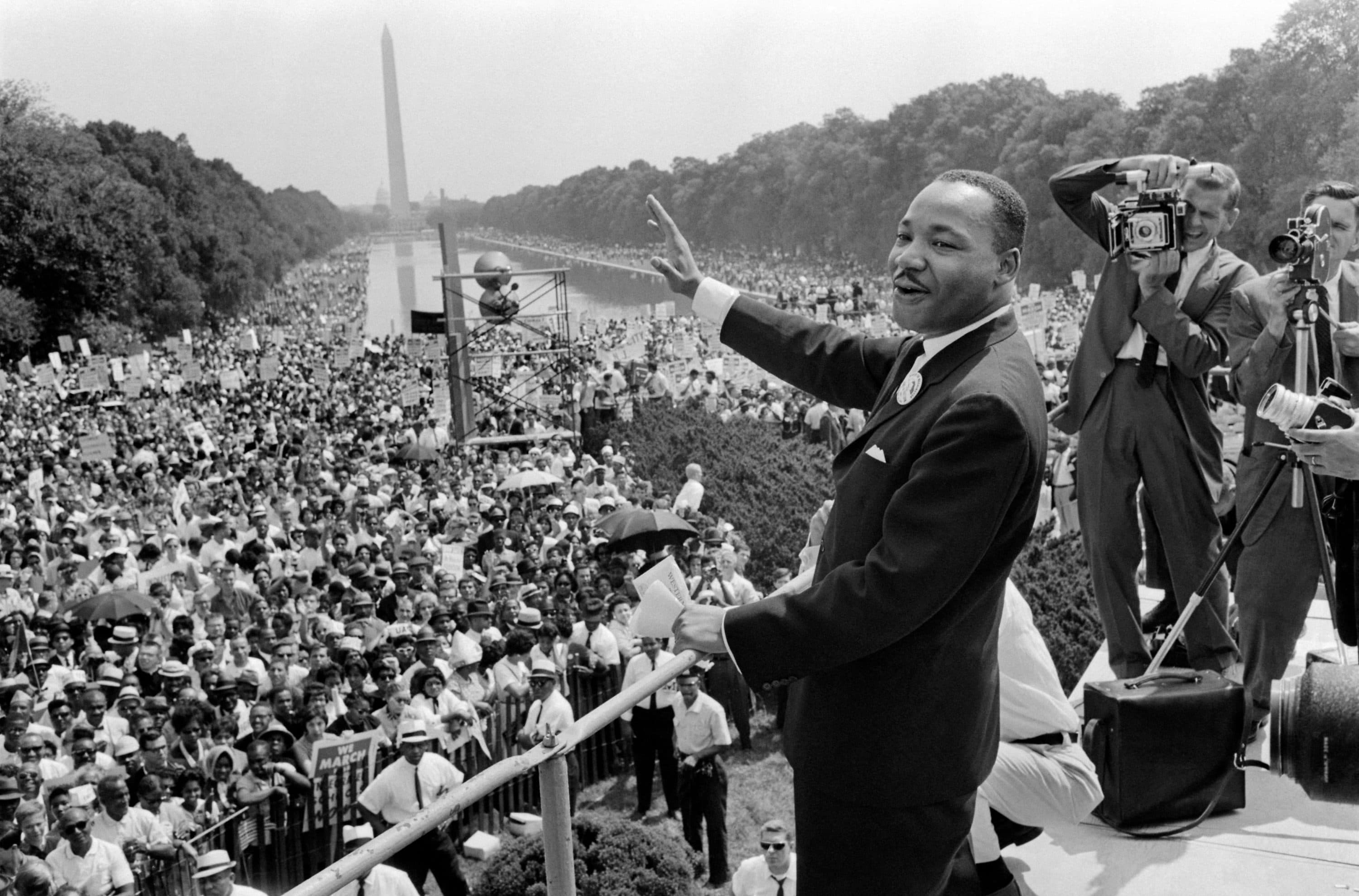 The civil rights leader Martin Luther King Jr., center, waves to supporters Aug. 28, 1963 on the Mall in Washington DC during the March on Washington. King said the march was "the greatest demonstration of freedom in the history of the United States. (AFP via Getty Images)