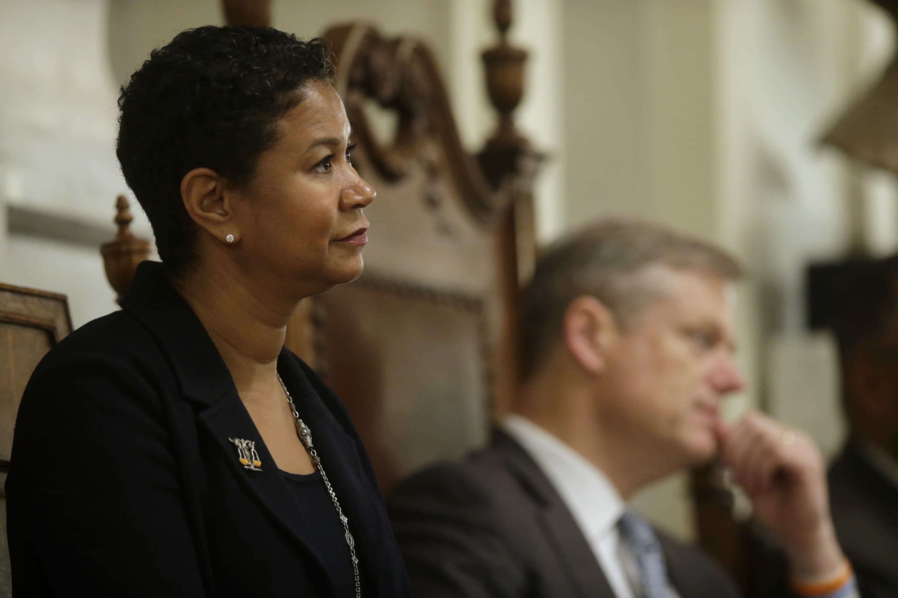 Massachusetts Supreme Judicial Court justice Kimberly Budd, left, is seated next to former Mass. Gov. Charlie Baker, right, Nov. 21, 2016, during a ceremonial swearing-in ceremony for Budd at Faneuil Hall, in Boston. (Steven Senne/AP)