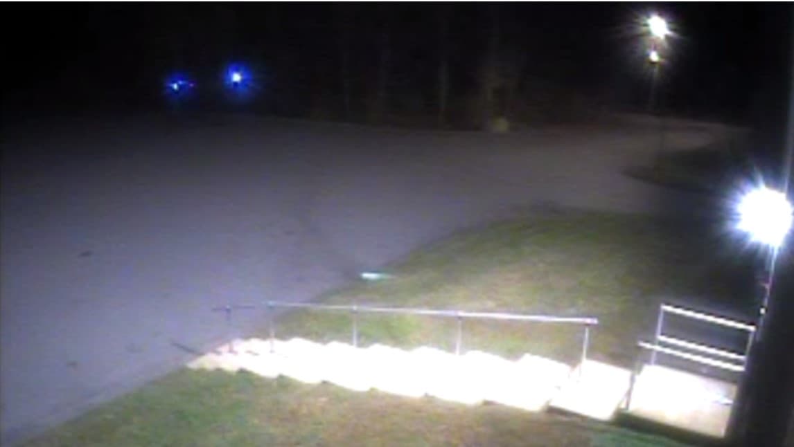 A surveillance camera in the industrial park captured a video of headlights and police lights as the shooting unfolded. (Courtesy of Bristol County District Attorney's Office via Law Offices of Joseph J. Voccola &amp;amp; Associates)