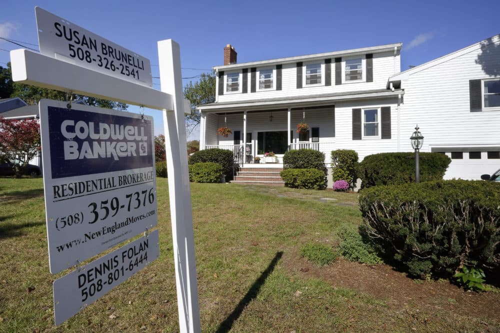 A real estate brokerage sign stands in front of a house in Norwood, Mass. in 2020. (Steven Senne/AP)