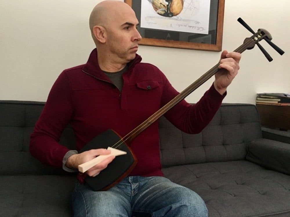 Eric Shimelonis plays the shamisen: a Japanese lute derived from the sanxian – a Chinese stringed instrument with a snakeskin-covered drum-like body – which was introduced to Japan during the sixteenth century. (Courtesy of Rebecca Sheir)