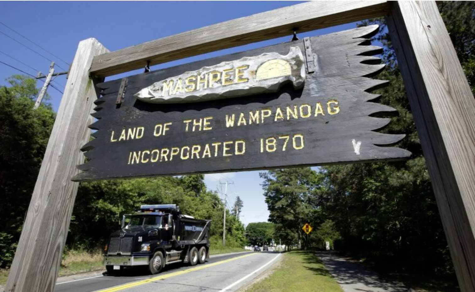 A wooden sign advises motorists of the location of Mashpee Wampanoag tribal lands in Massachusetts. (Steven Senne/AP)