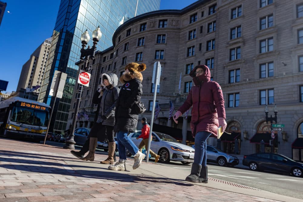 Bundled up people walking down Dartmouth Street toward Copley Square in the cold weather. (Jesse Costa/WBUR)