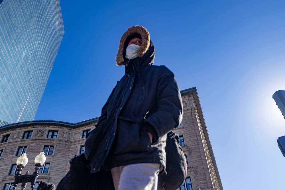 A man braces against the cold as he walks down Dartmouth Street toward Copley Square. (Jesse Costa/WBUR)