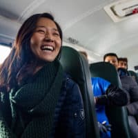 Mayor Michelle Wu smiles during her ride in the first electric school bus added to the Boston Public Schools’ fleet. (Jesse Costa/WBUR)