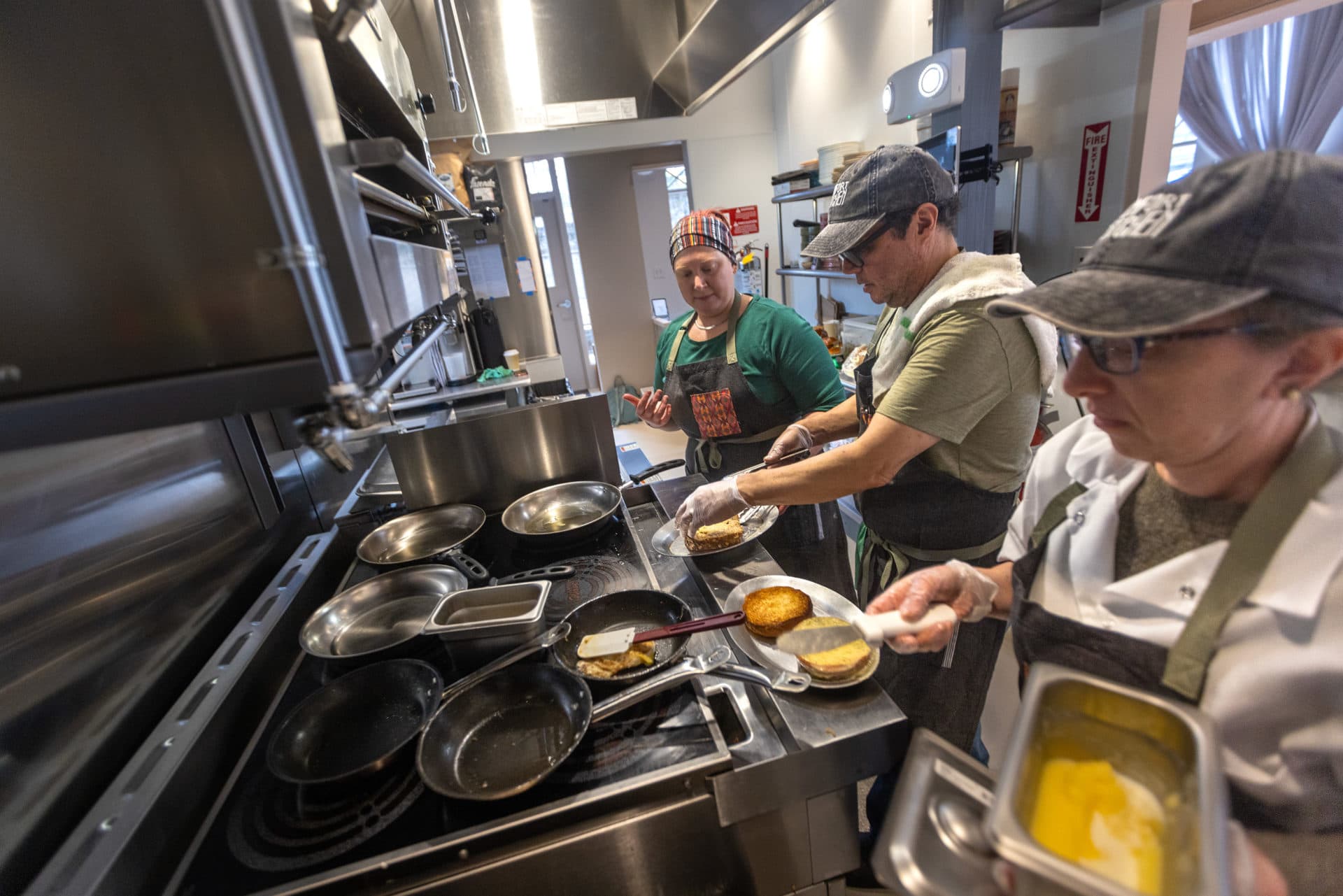 Employees prepare lunch and breakfast sandwiches in the kitchen at Dorchester's Comfort Kitchen. (Jesse Costa/WBUR)