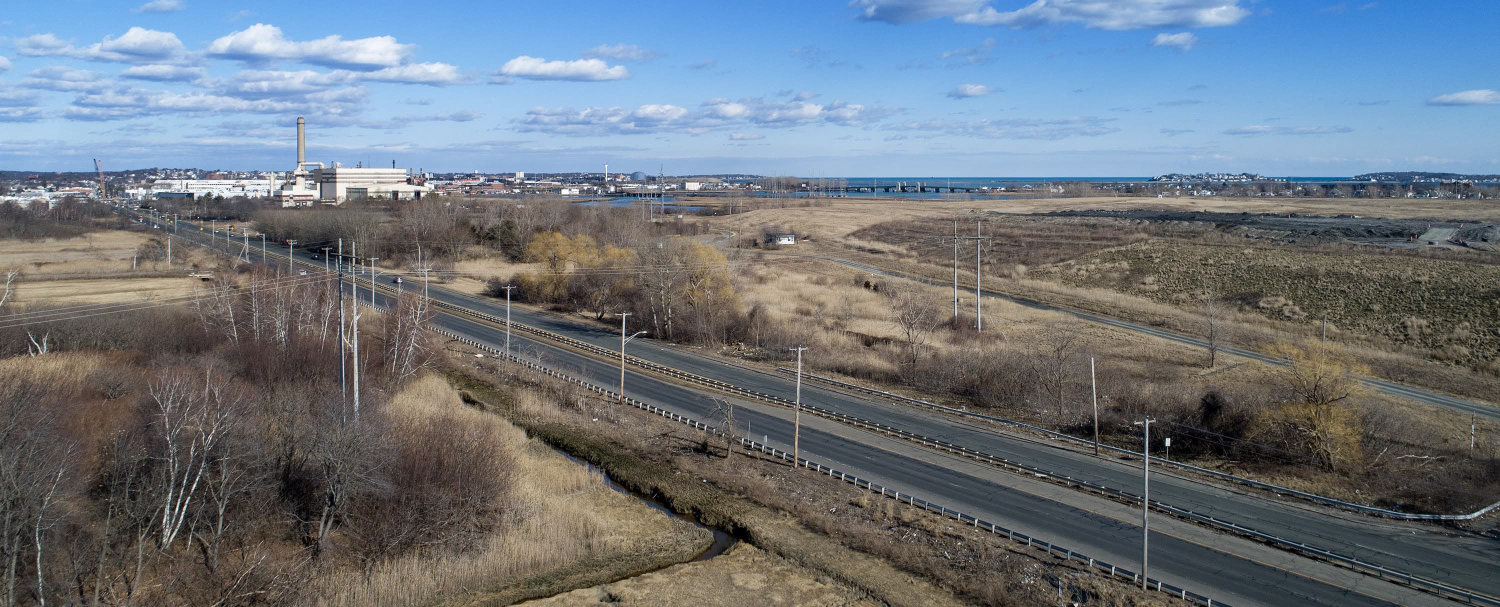 The WIN Waste incinerator in Saugus in located at Rumney Marsh. Its ash landfill stretches to the right next to the Salem Turnpike. (Credit: Robin Lubbock/WBUR)