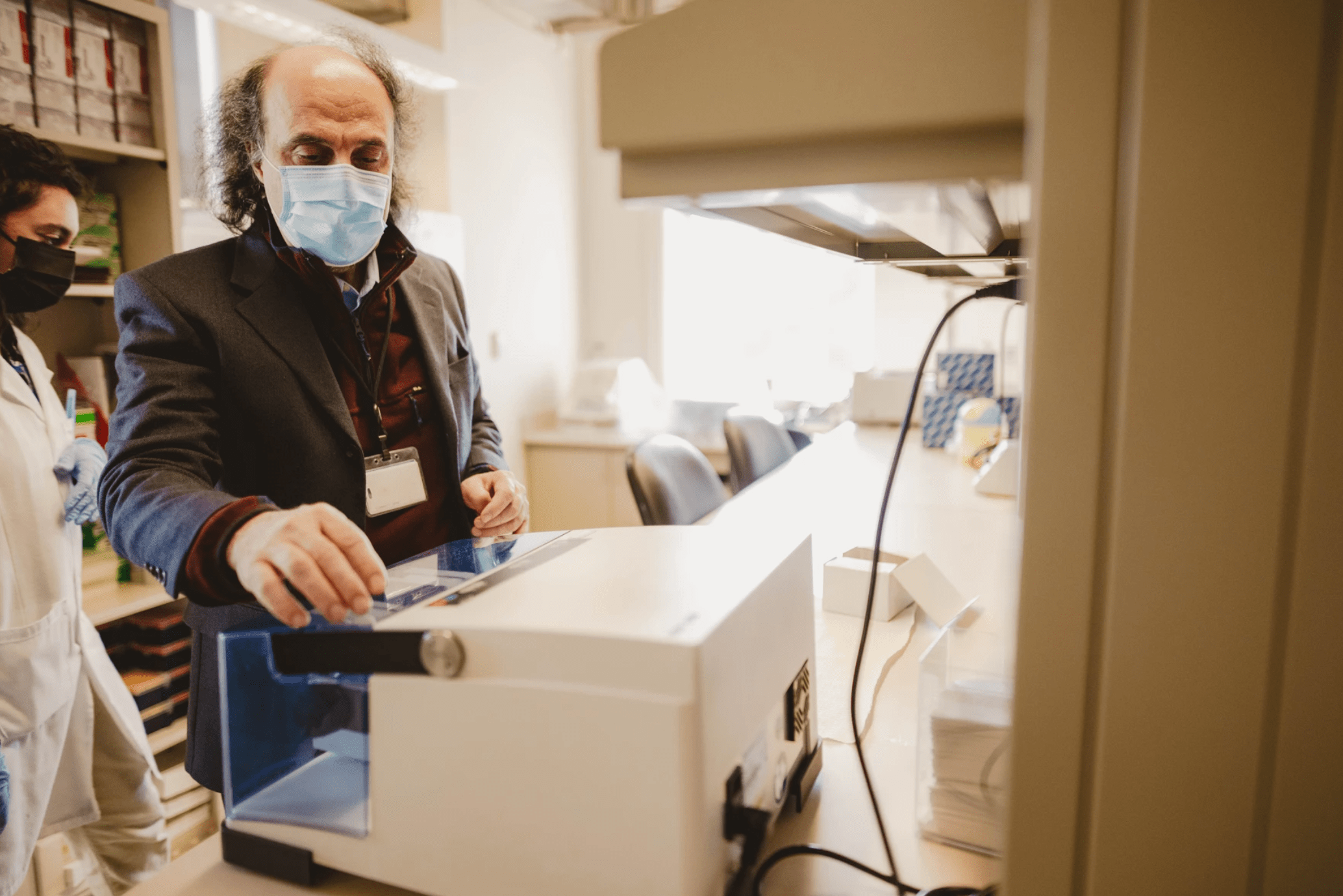 Dr. Goudarz Molaei uses a mixer machine to further inspect a local tick at the Connecticut Agricultural Experiment Station in New Haven on Feb. 8. (Tony Spinelli/Connecticut Public)