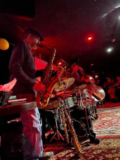 Jeff Robinson plays the saxophone at a Lizard Lounge Poetry Jam. (Cristela Guerra/WBUR)