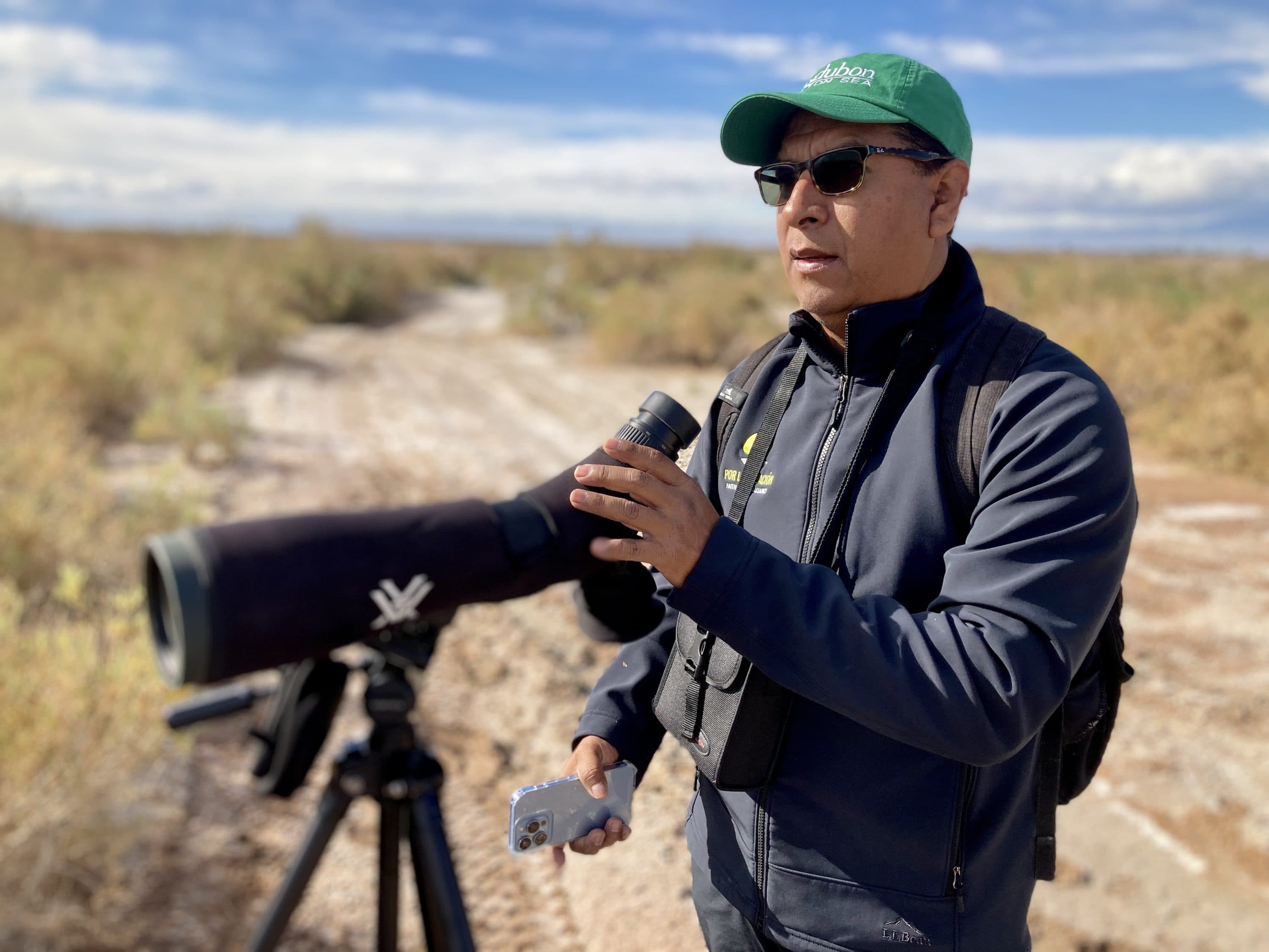 Audubon California’s Frank Ruiz looks for migratory birds at a wetland near Bombay Beach. (Peter O'Dowd/Here &amp; Now)