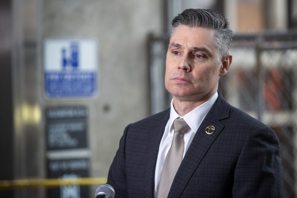 MBTA Interim General Manager Jeff Gonneville listens to a question from a reporter at Alewife MBTA station. (Robin Lubbock/WBUR)