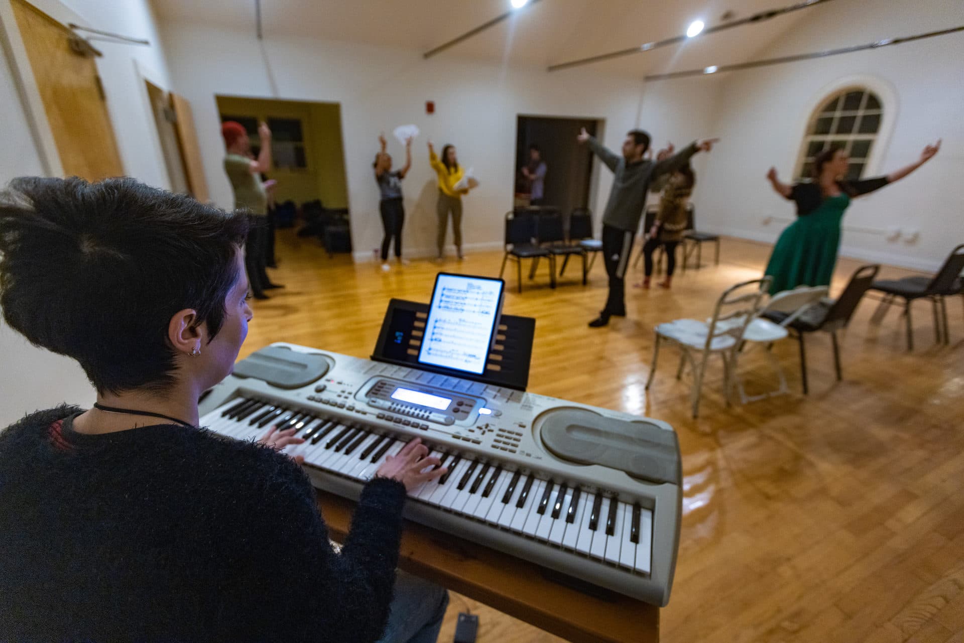 Composer Melissa Carubia and the cast of “T: An MBTA Musical” rehearse ahead of their new season of shows beginning in March at the Rockwell in Davis Square. (Jesse Costa/WBUR)