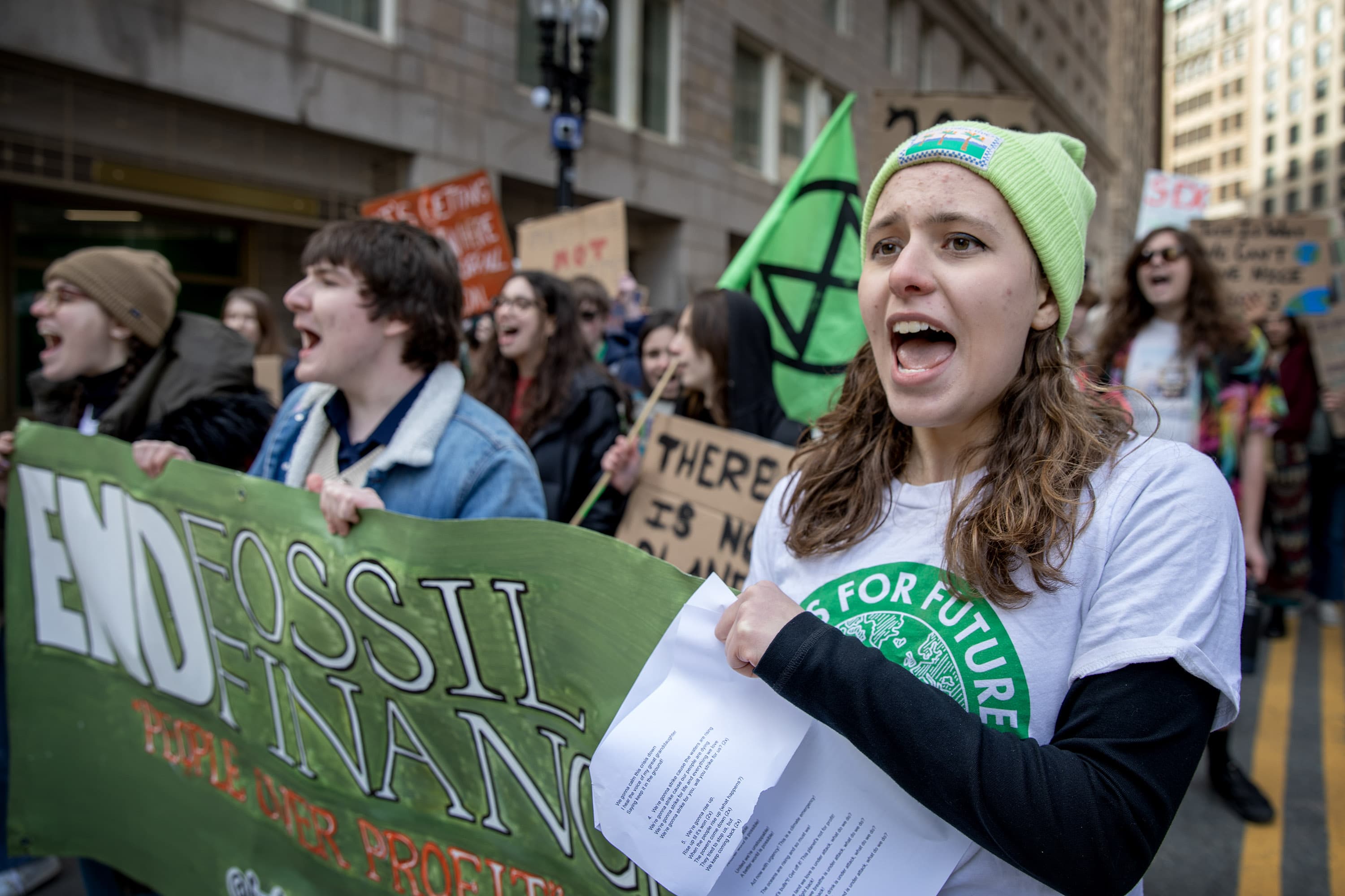 Fridays For Future Boston organizer Shoshana Daly leads students on a march through downtown Boston. (Credit: Robin Lubbock/WBUR)