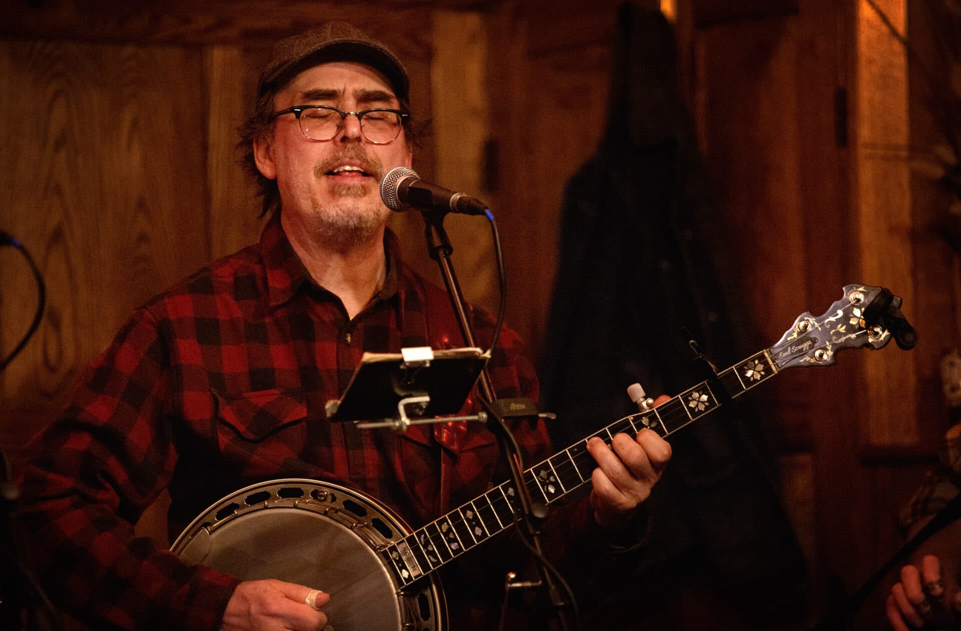 Eric Royer plays banjo as he sings with members of the Royer Family Band at Atwood's on Cambridge Street in Cambridge. (Robin Lubbock/WBUR)