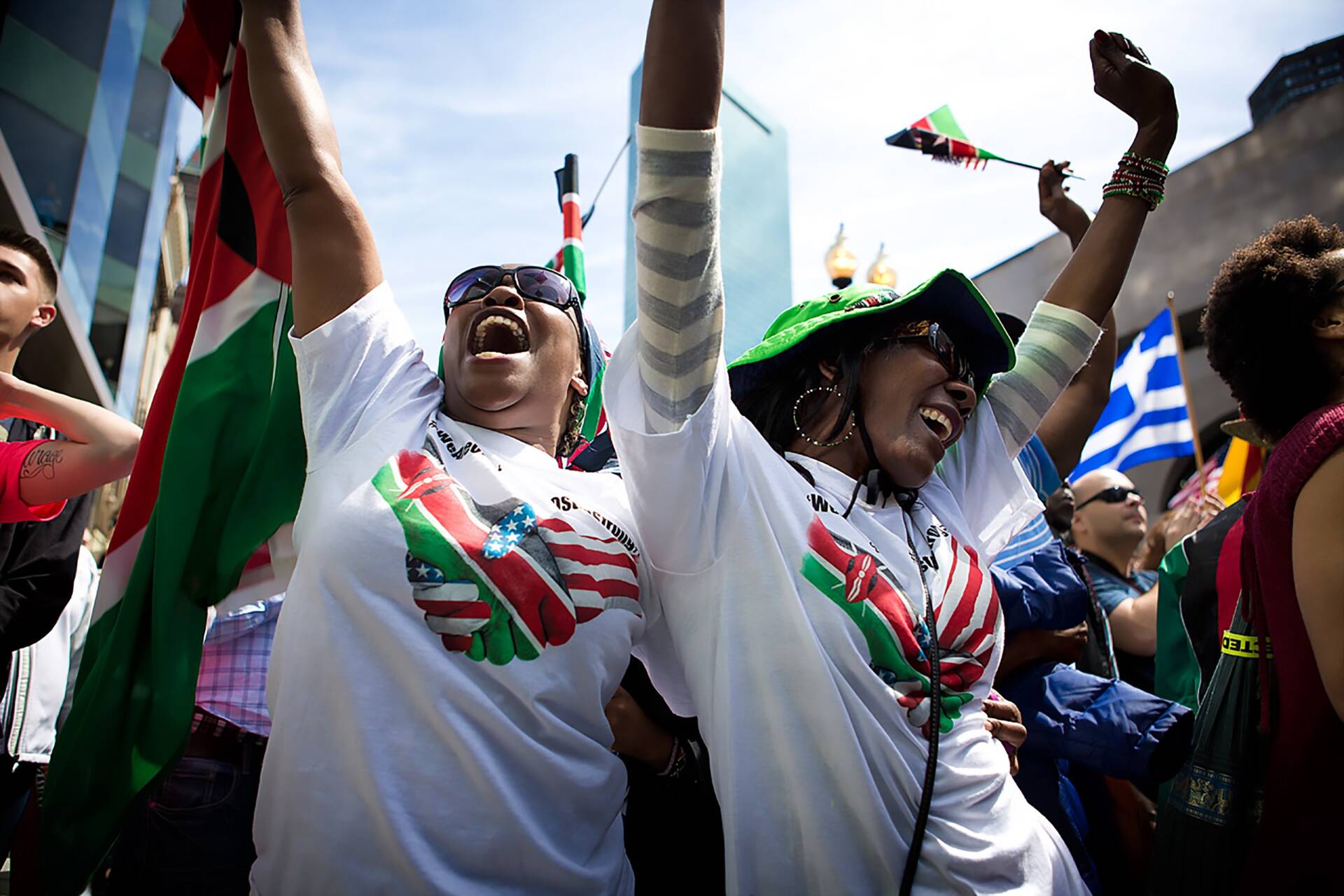 Eunice Walerui and Jane Wanja of Kenya celebrate Rita Jeptoo's 2014 win. They had, at that point, attended the last five Boston Marathon races. (Jesse Costa/WBUR)