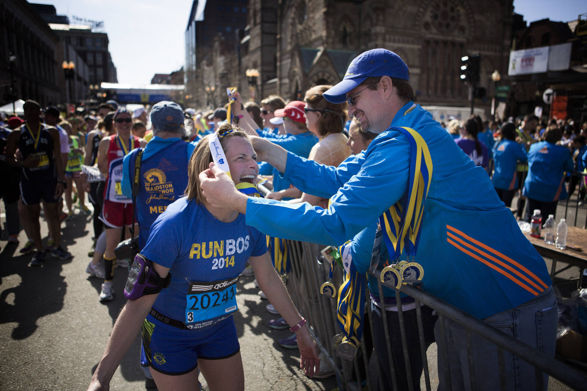 A runner receives her medal for completing the Boston Marathon. (Jesse Costa/WBUR)