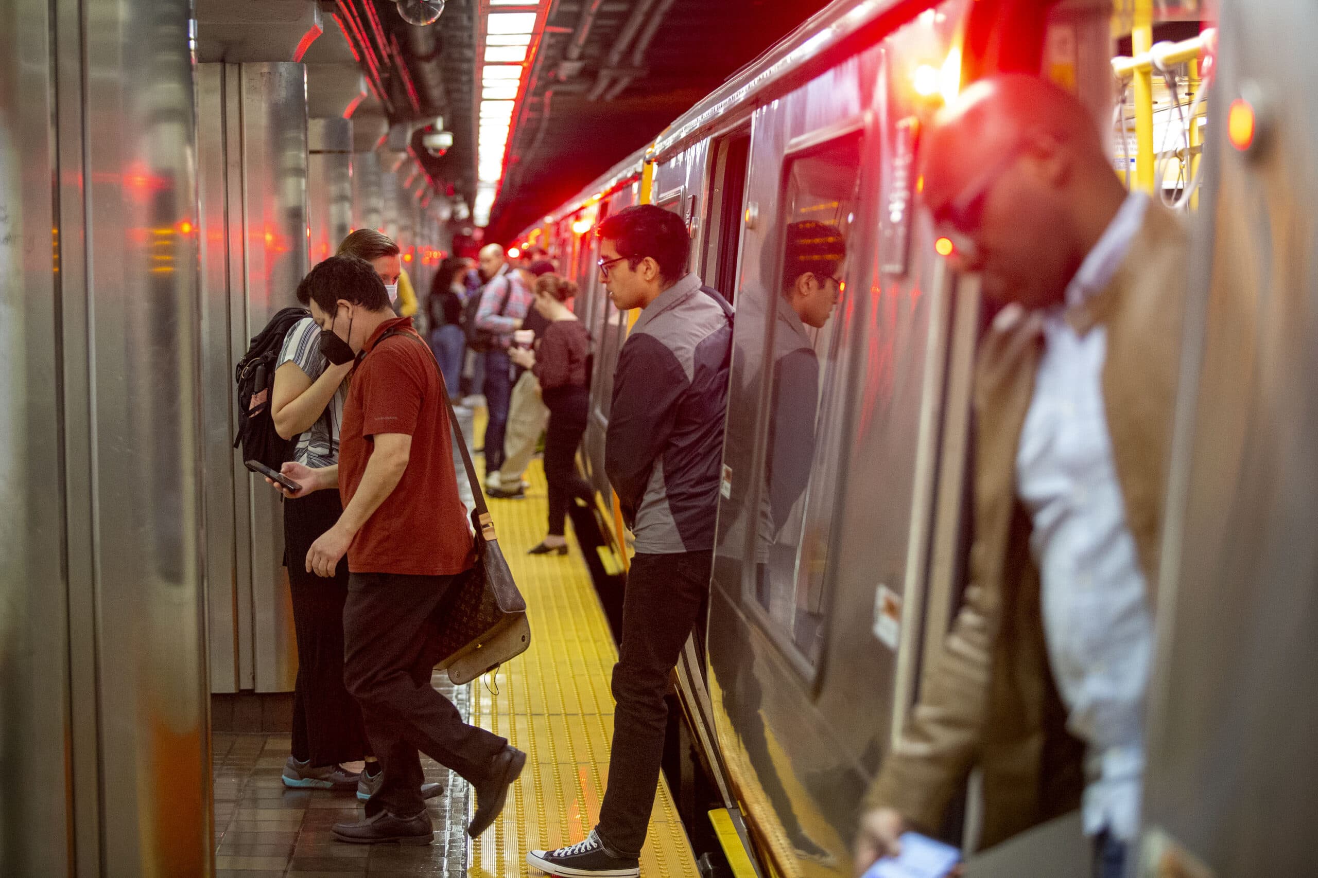 Passengers hustle on and off an Orange Line MBTA train when its doors open at Downtown Crossing. (Robin Lubbock/WBUR)