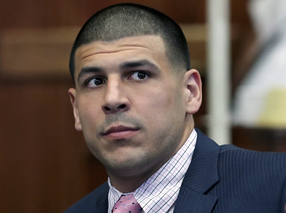 FILE - In this Oct. 5, 2016 file photo, former New England Patriots NFL football player Aaron Hernandez listens during a status conference before his double murder trial at Suffolk Superior Court in Boston. A wrongful death suit by the families of Daniel de Abreu and Safiro Furtado, the two men Hernandez had been accused of killing in 2012, was settled on Tuesday, July 23, 2019. Hernandez was acquitted in the criminal murder trial in 2017, but hanged himself in prison just days later while serving a life sentence for for the 2013 murder of Odin Lloyd. (John Blanding/The Boston Globe via AP, Pool, File)
