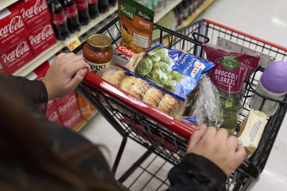 A woman who depends on California's SNAP benefits to help pay for food shops for groceries at a supermarket in Bellflower, Calif., on Monday, Feb. 13, 2023. (Allison Dinner/Here & Now)