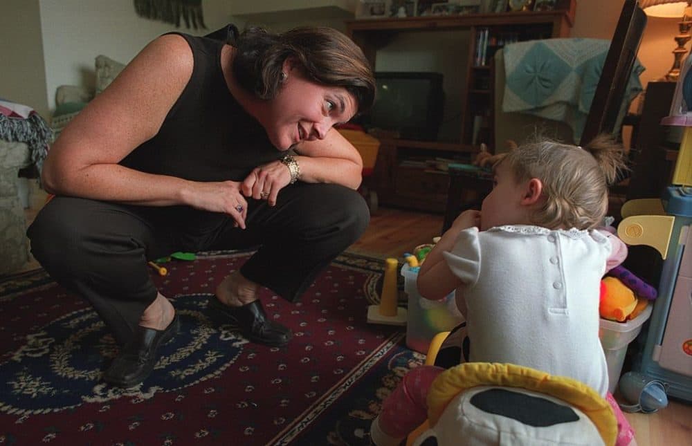On Sept. 26, 2002, acting Gov. Jane Swift plays with Lauren, one of her 16-month-old twins, at home in Williamstown Thursday morning before leaving for work at the State House. (Michele McDonald/The Boston Globe via Getty Images)