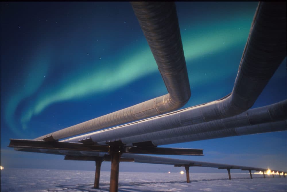 A full moon helps illuminate the Alaskan pipeline under the faint glow of the Aurora Borealis. (Greg A. Syverson/Getty Images)