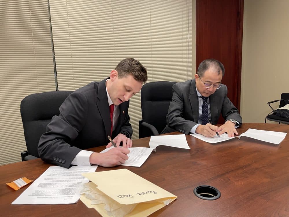 Evan Kail signing paperwork at the Chinese Consulate in Chicago. This agreement between Evan, his lawyer, and the Consul General of the PRC in Chicago, officially relinquished the photo album to the Chinese government. According to Evan, the book is now in China and being inspected by historians. (Courtesy Evan Kail)