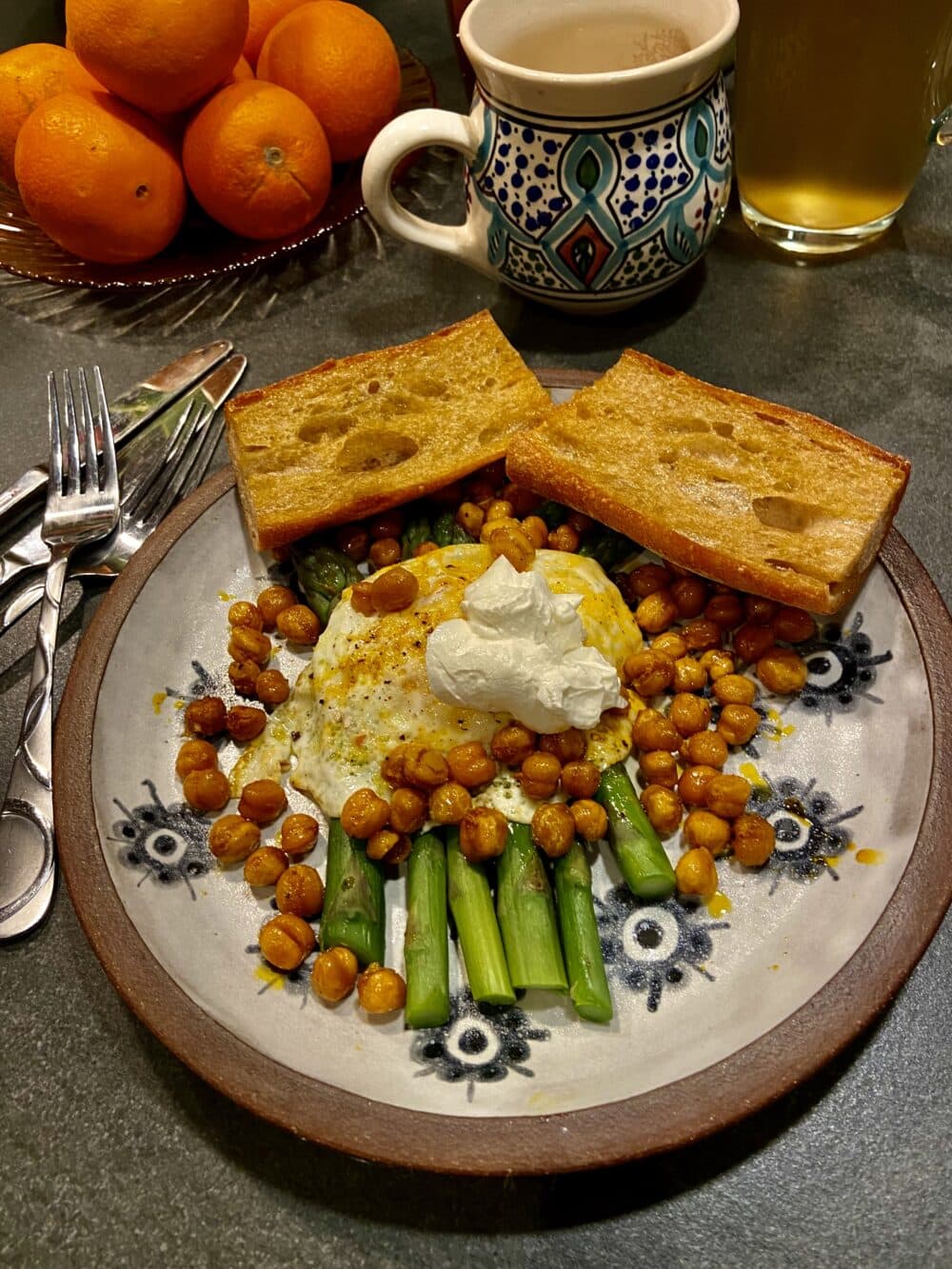 Fried eggs, asparagus, and oven-roasted chickpeas with olive oil toasted baguette. (Kathy Gunst/Here &amp; Now)