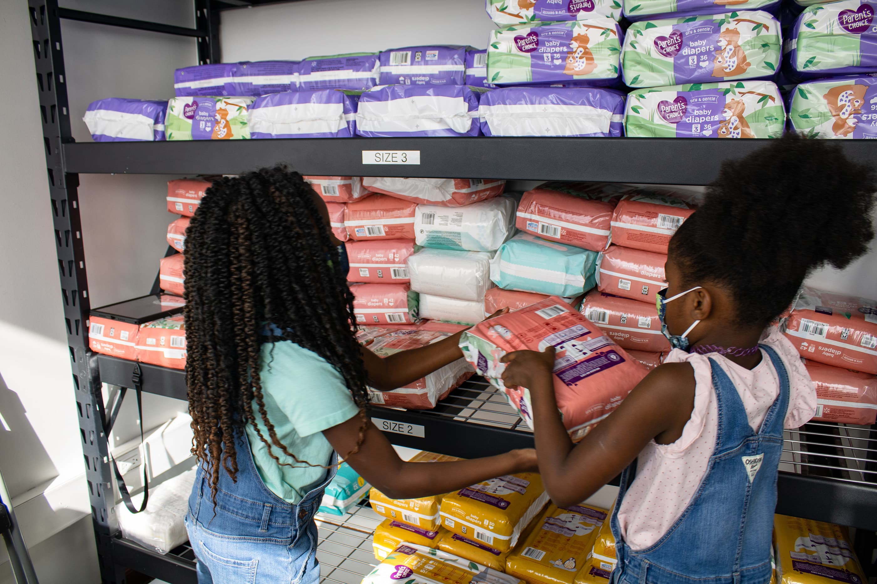 Chantal Alison-Konteh and her two children, Zoe, 9 and Zara, 7, relied on diaper banks when the girls were babies. Now it's a full-circle moment with her daughters helping her distribute diapers to families who need help. (Courtesy of Chantal Alison-Konteh)