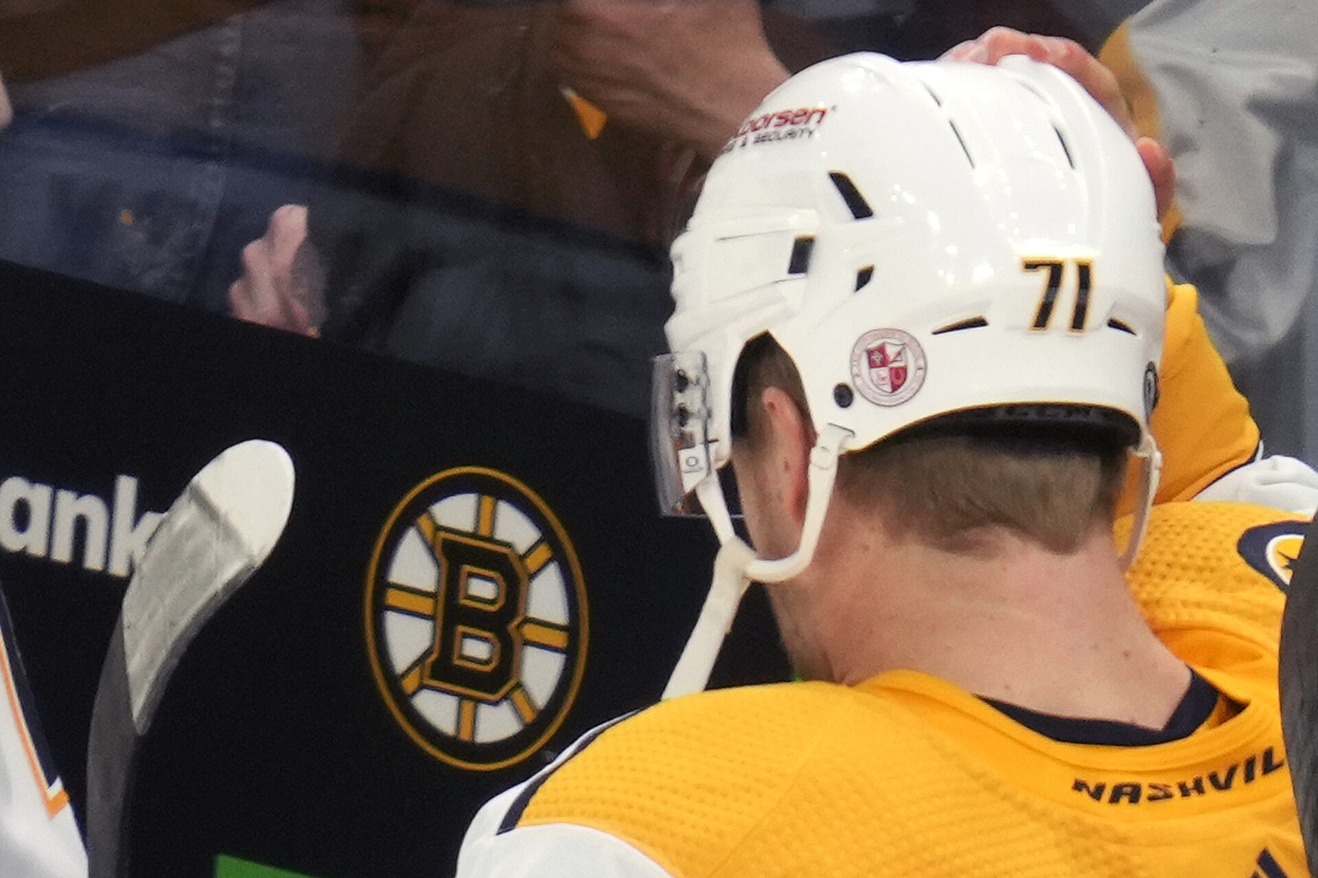 The logo of Nashville's Covenant School is displayed on the back of Nashville Predators center Rasmus Asplund's helmet, in honor of the school shooting victims, before the team's NHL hockey game against the Bruins, March 28, in Boston. (Charles Krupa/AP)